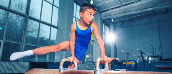 Elementary school student practicing artistic gymnastic Elementary school student practicing artistic gymnastic