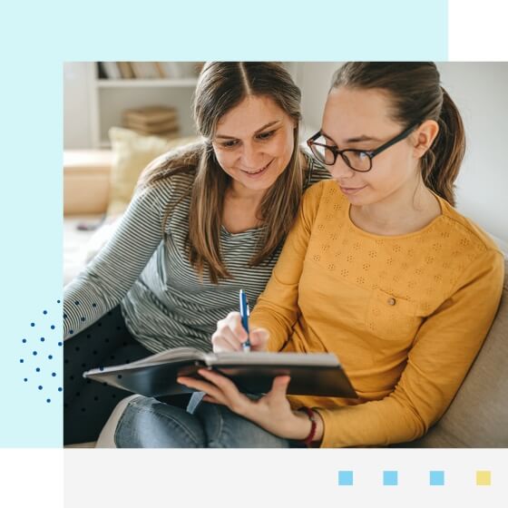 Image of mother and daughter taking notes